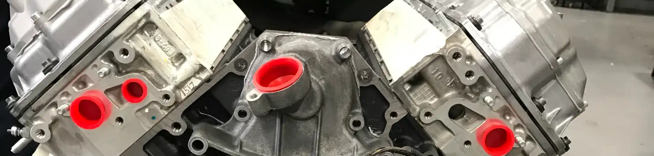 Diesel Repair in St. Cloud, FL at FloState Auto Diesel Repair. Close-up view of a diesel engine component with red-capped openings, prepared for repair and maintenance.