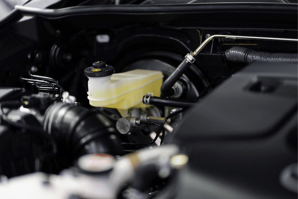 brake fluid maintenance, auto repair in St Cloud, FL at FloState Auto Diesel Repair. Close-up view of a brake fluid reservoir in a modern vehicle engine bay.