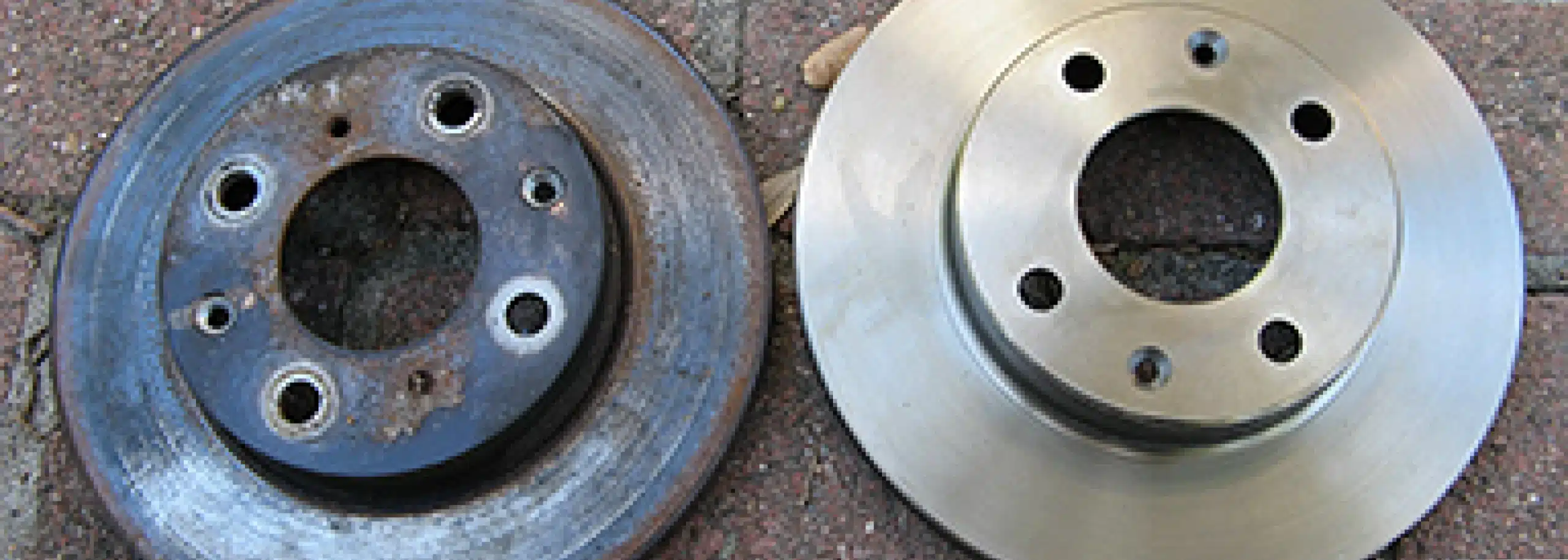 Comparison of a worn brake rotor on the left and a new brake rotor on the right.