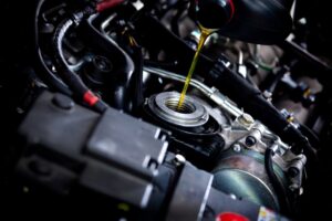 an oil being poured into a car engine, Oil Change Services In St Cloud, FL At FloState Auto Diesel Repair