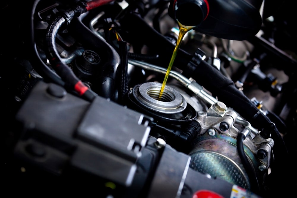 an oil being poured into a car engine, Oil Change Services In St Cloud, FL At FloState Auto Diesel Repair