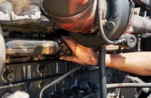 Technician repairing a heavy-duty diesel engine turbocharger at a professional diesel repair shop