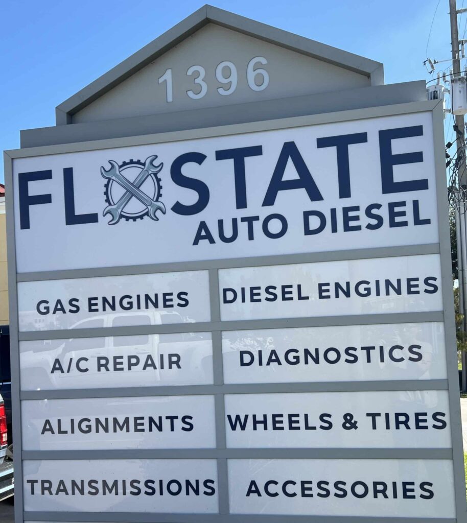Roadside sign for Flo State Auto Diesel with service offerings.
