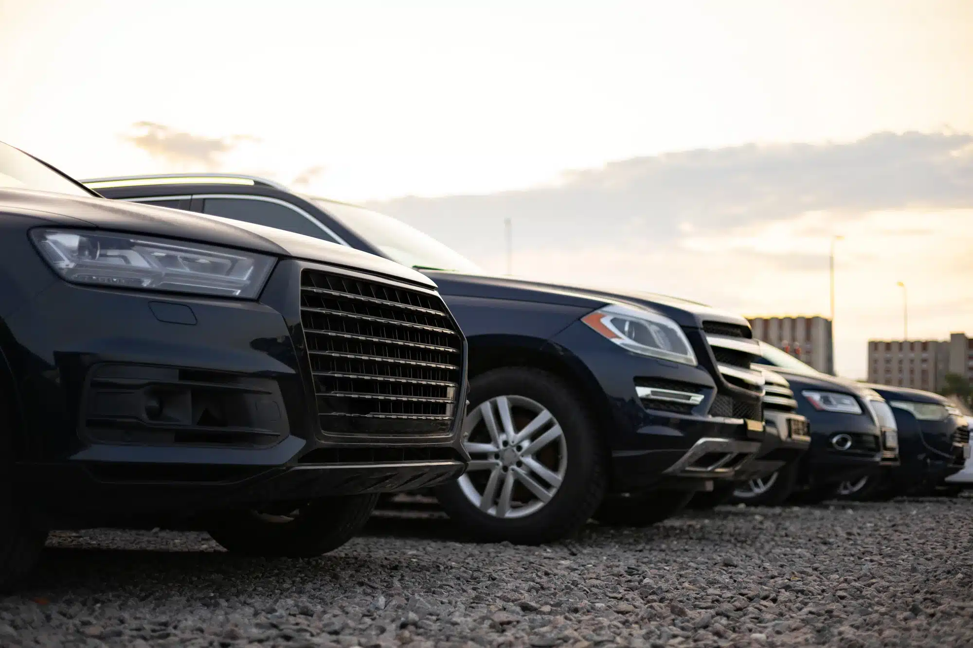 Row of passenger vehicles parked outside a professional auto repair and maintenance shop