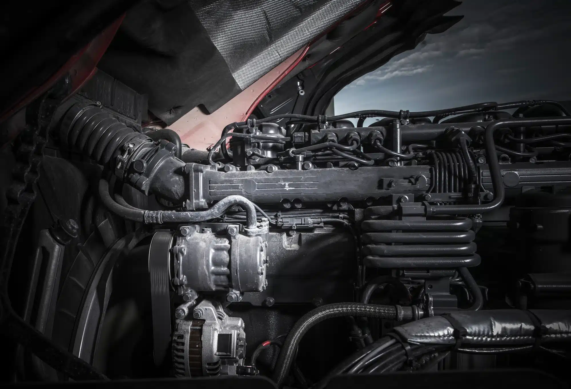 Heavy-duty diesel truck engine undergoing professional inspection and repair at an auto diesel repair shop